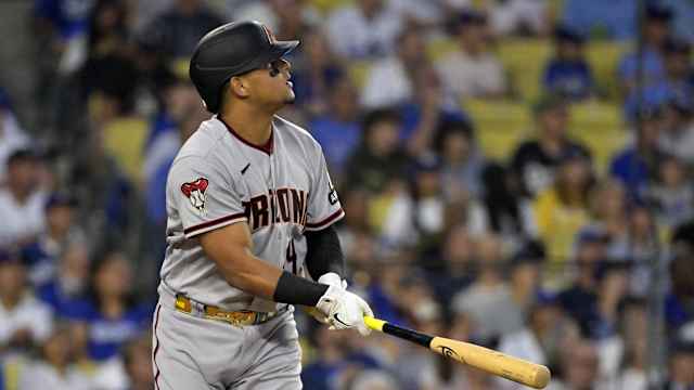 Arizona Diamondbacks catcher Gabriel Moreno (14) watches his three-run home run sail into the left field bleachers in Dodger Stadium in the first inning of Game 1 of the National League Division Series.